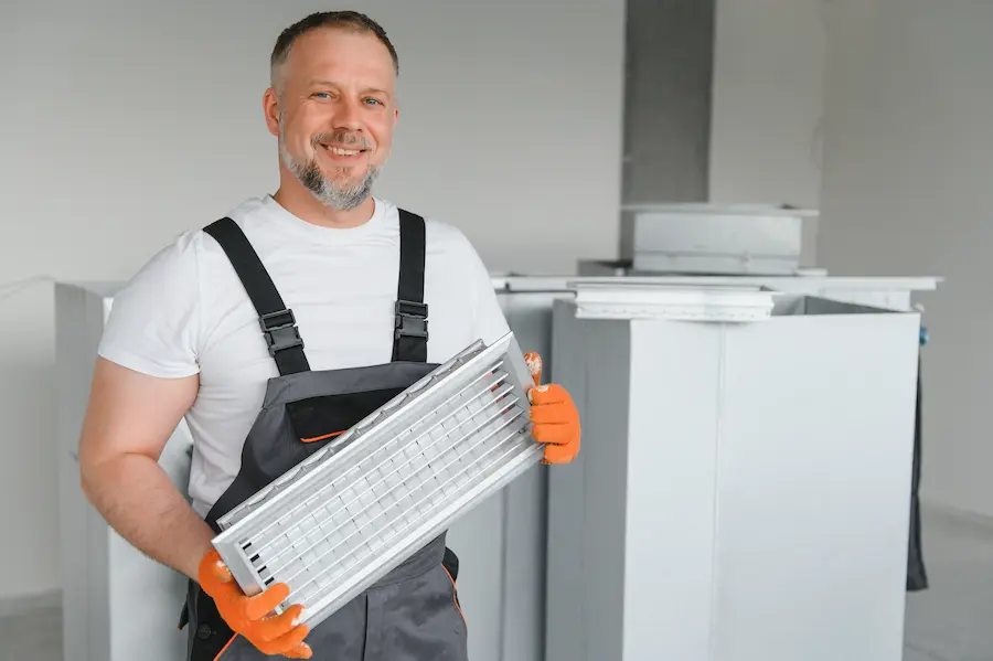 A Male Worker Holds An Air Filter For Air Conditio 2023 11 27 05 12 20 Utc