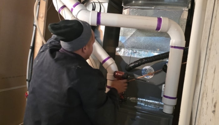 Technician Working On Furnace Technician Working On Furnace